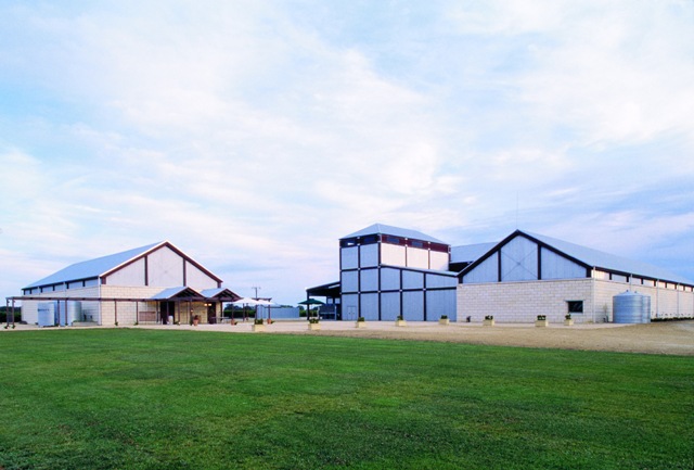 winery buildings landscape and a grassy field in the foreground