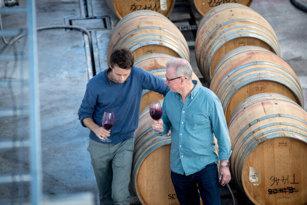 two men and wine barrels