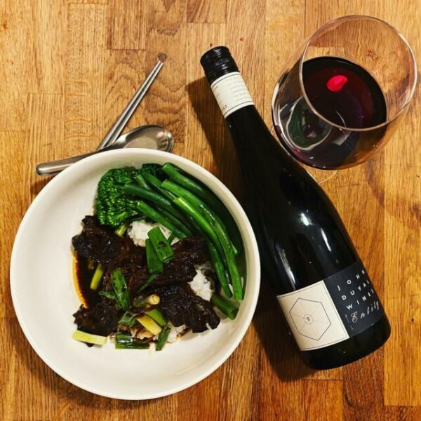 plate of food, wine bottle and wine glass